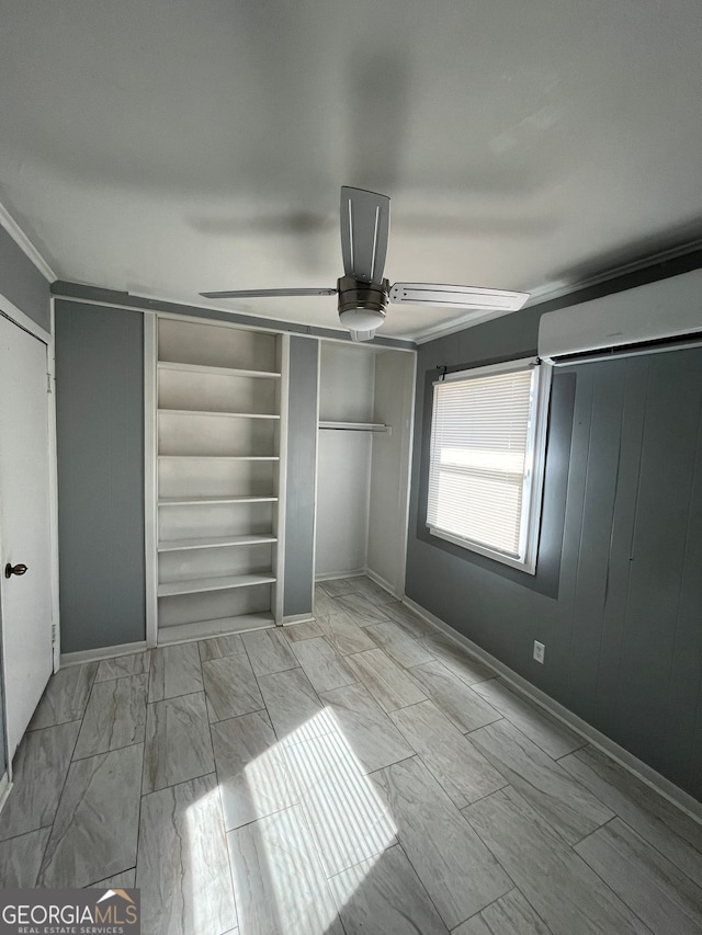 unfurnished bedroom featuring crown molding, an AC wall unit, a closet, and ceiling fan