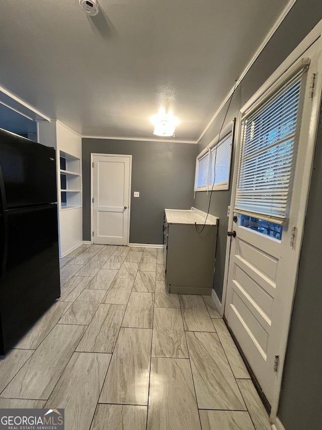 laundry area featuring crown molding