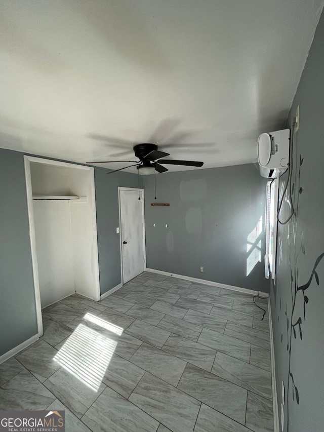 unfurnished bedroom with ceiling fan and a closet