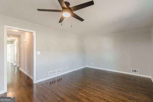 spare room with dark wood-type flooring and ceiling fan