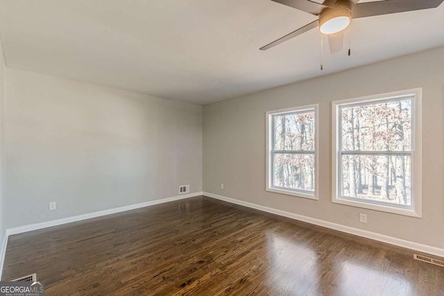 spare room with ceiling fan and dark hardwood / wood-style floors