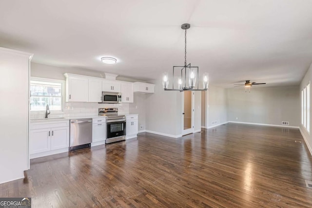 kitchen featuring white cabinetry, sink, dark hardwood / wood-style floors, and appliances with stainless steel finishes