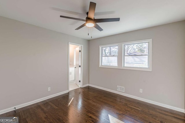 unfurnished bedroom featuring dark hardwood / wood-style flooring, ceiling fan, and ensuite bathroom