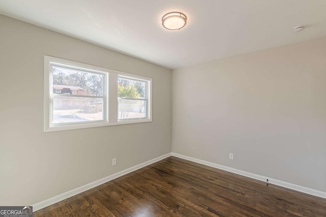 spare room featuring dark wood-type flooring