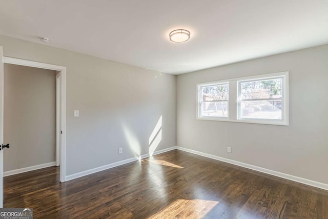 unfurnished room featuring dark hardwood / wood-style floors