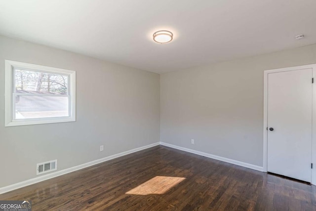 unfurnished room with dark hardwood / wood-style floors