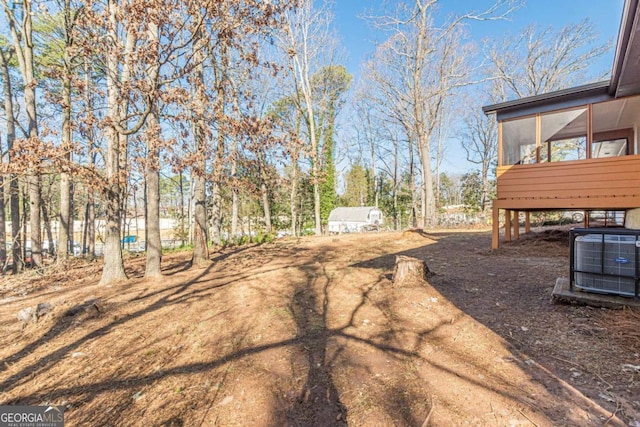 view of yard featuring a sunroom and cooling unit