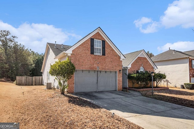 view of front of house with central AC and a garage