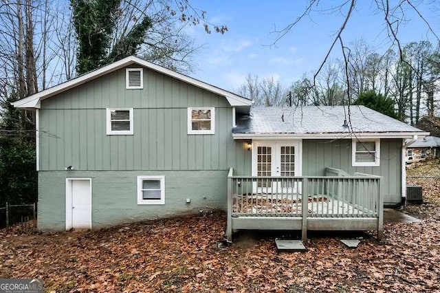 rear view of house featuring a deck and french doors