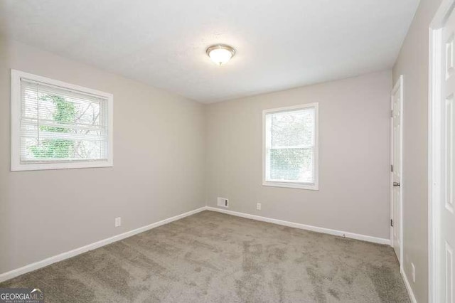 spare room with light colored carpet