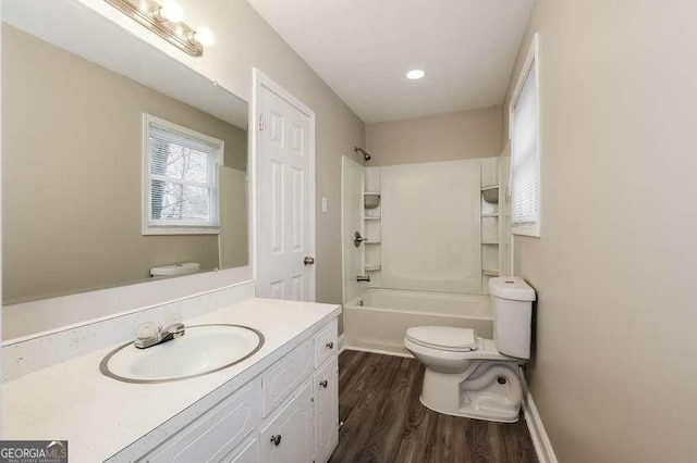 full bathroom with vanity, shower / bathing tub combination, hardwood / wood-style floors, and toilet