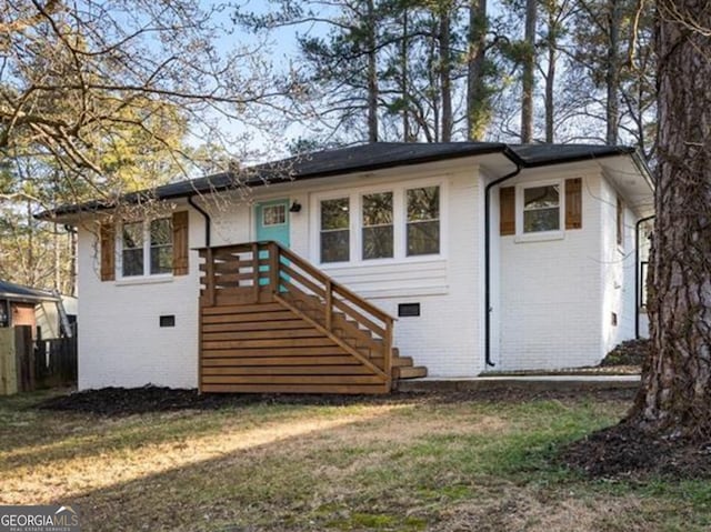 rear view of house with a yard