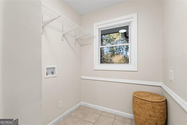 laundry room featuring hookup for a washing machine and light tile patterned floors