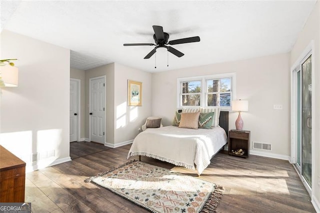 bedroom with ceiling fan and dark hardwood / wood-style flooring