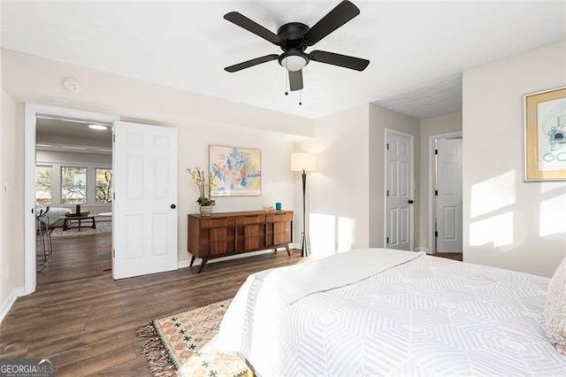 bedroom with dark wood-type flooring and ceiling fan