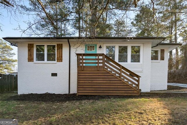 rear view of property with a yard and central air condition unit