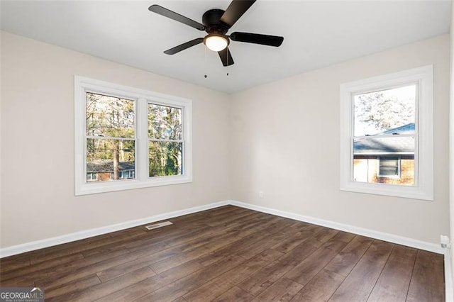 empty room with dark wood-type flooring and ceiling fan