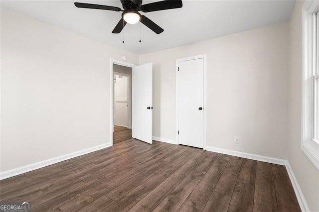 unfurnished bedroom with dark wood-type flooring and ceiling fan