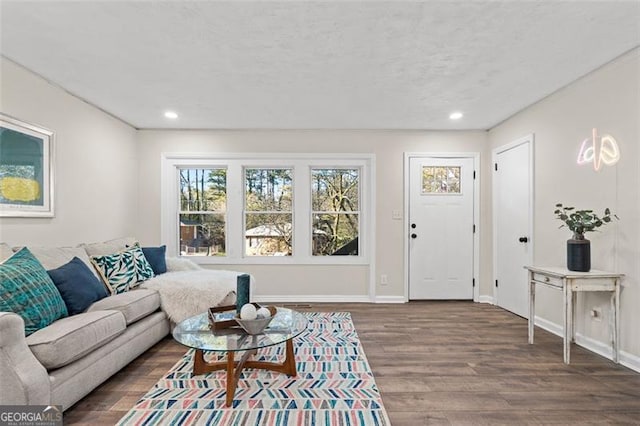 living room with dark wood-type flooring and a textured ceiling