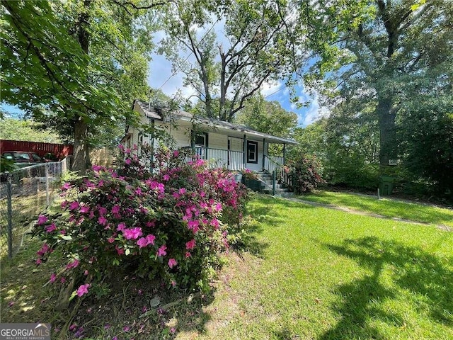 view of yard featuring covered porch