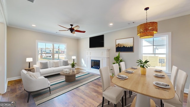 dining room with crown molding, ceiling fan, and hardwood / wood-style flooring