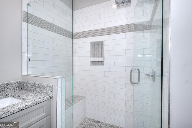 bathroom featuring sink and a shower with door