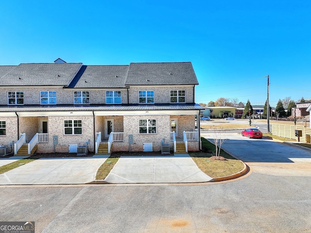 rear view of property with central AC and covered porch