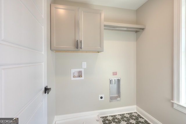 laundry room with hookup for a washing machine, hookup for an electric dryer, and cabinets