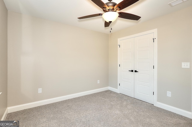 unfurnished bedroom featuring a closet, ceiling fan, and carpet flooring