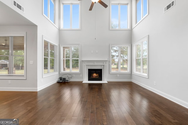 unfurnished living room with plenty of natural light and dark wood-type flooring