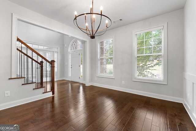 entryway featuring dark hardwood / wood-style flooring and a notable chandelier