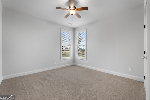 carpeted empty room featuring ceiling fan