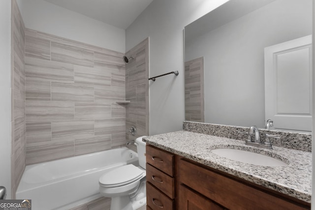 full bathroom with vanity, tiled shower / bath, and toilet