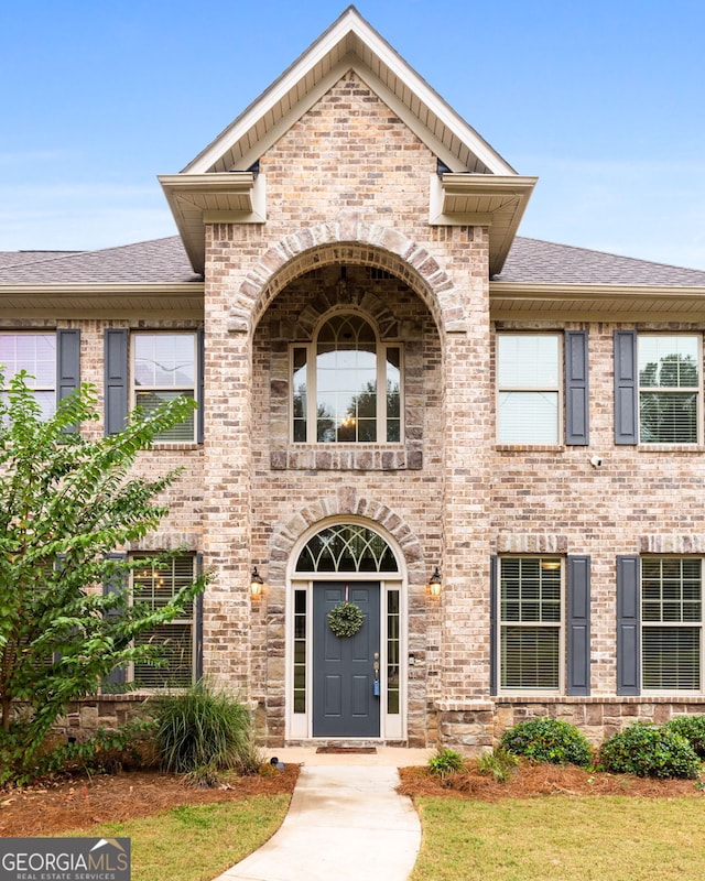 entrance to property with a lawn