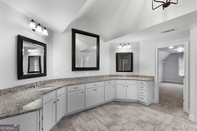 bathroom featuring vanity and vaulted ceiling