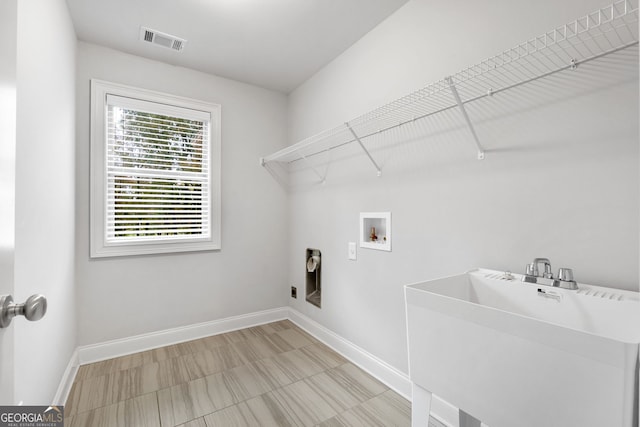 washroom featuring hookup for a washing machine, sink, and hookup for an electric dryer