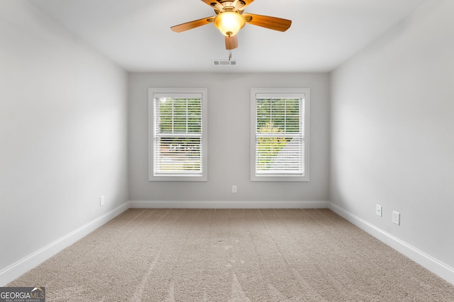 spare room featuring ceiling fan and carpet flooring