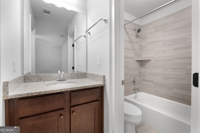 full bathroom with tiled shower / bath combo, vanity, and toilet