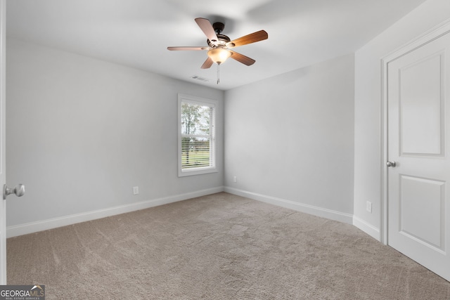 spare room featuring ceiling fan and carpet flooring