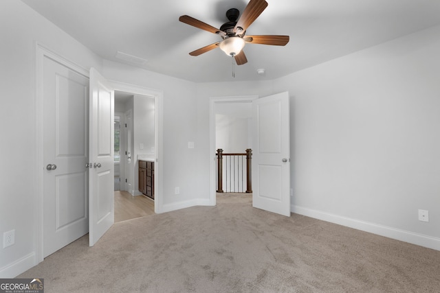 unfurnished bedroom featuring light colored carpet and ceiling fan