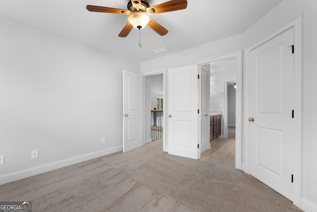 unfurnished bedroom featuring ceiling fan and light carpet