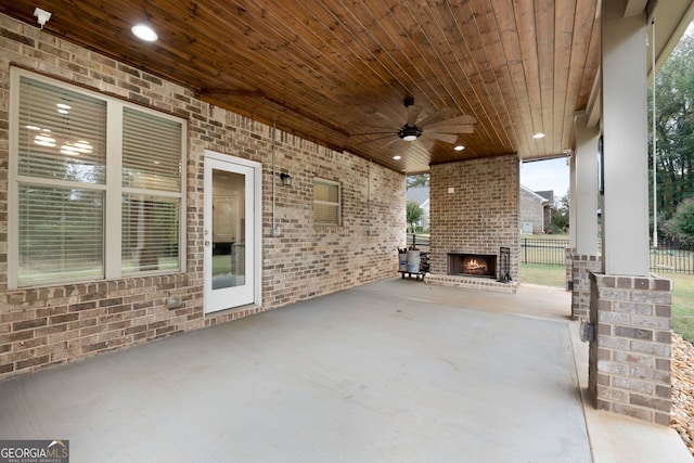 view of patio / terrace featuring an outdoor brick fireplace and ceiling fan