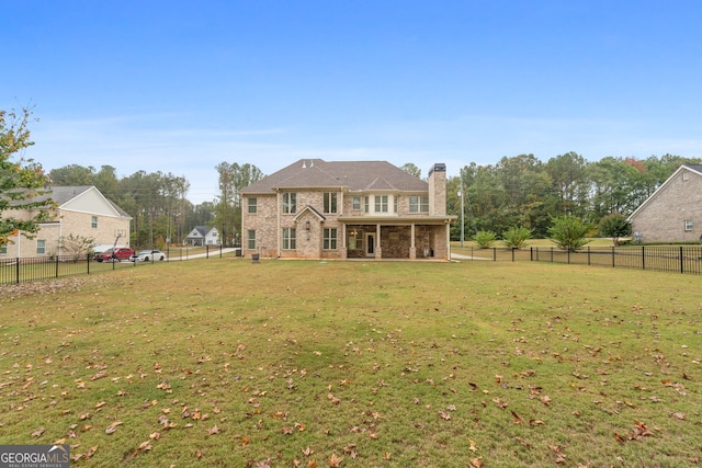 rear view of property featuring a yard