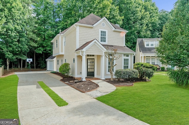 front facade featuring a garage and a front lawn