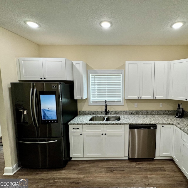 kitchen with white cabinetry, stainless steel appliances, and sink