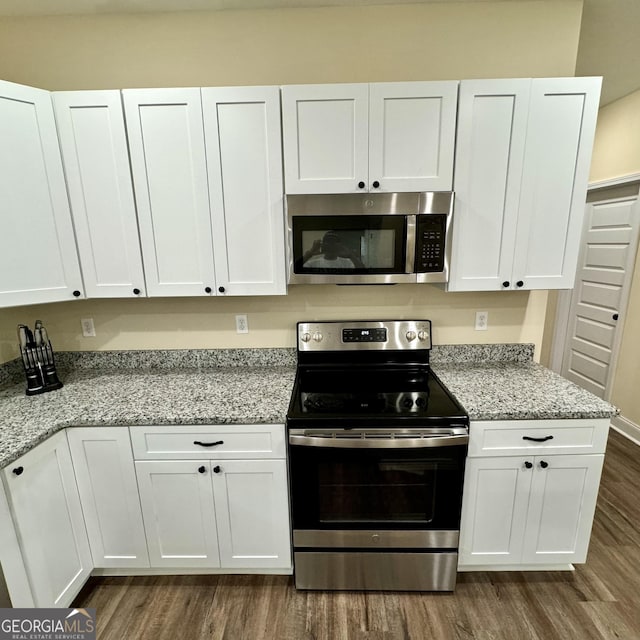 kitchen featuring white cabinetry, appliances with stainless steel finishes, and light stone counters