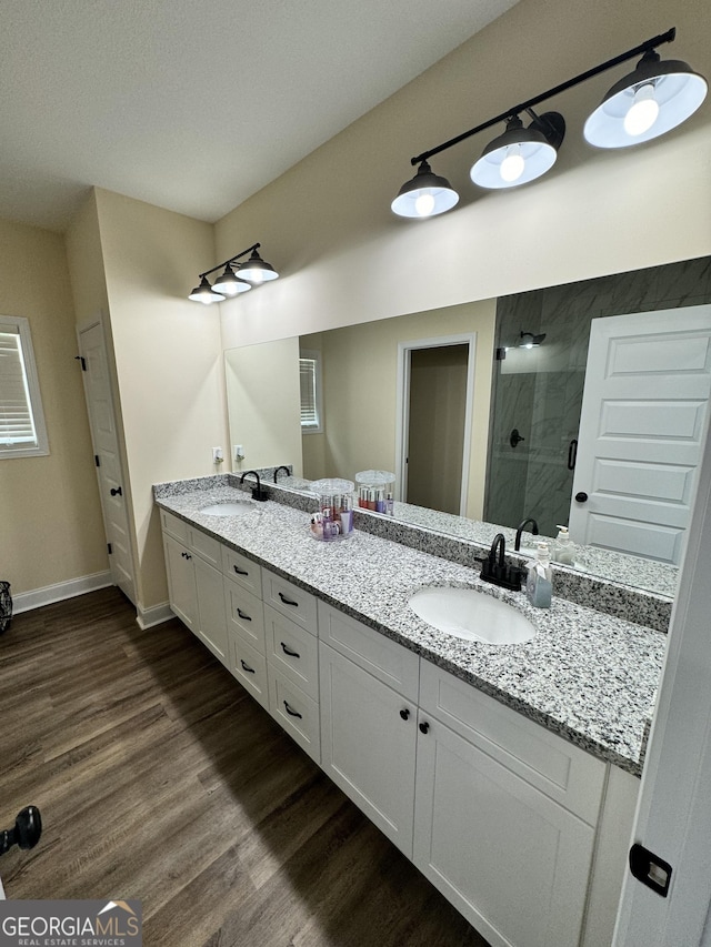 bathroom with vanity, hardwood / wood-style floors, and walk in shower