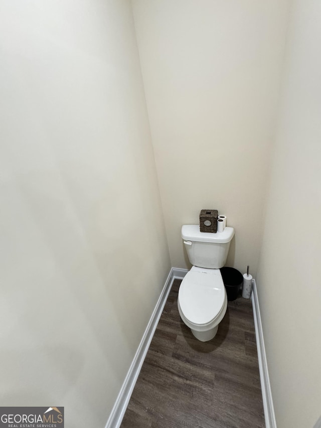 bathroom featuring hardwood / wood-style flooring and toilet