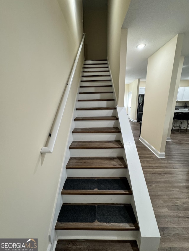 stairs with hardwood / wood-style floors