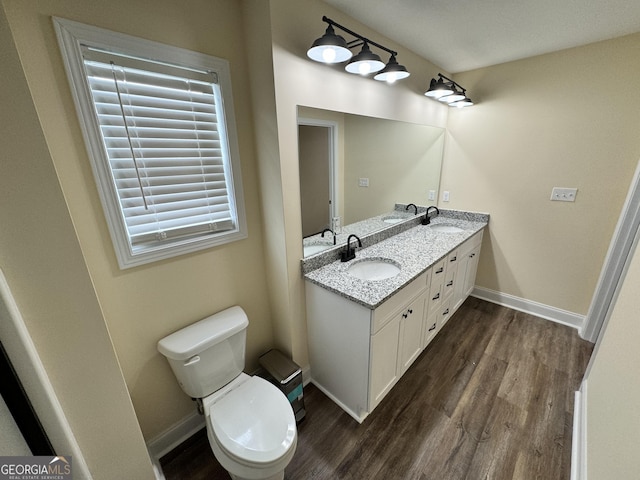 bathroom featuring vanity, toilet, and hardwood / wood-style floors